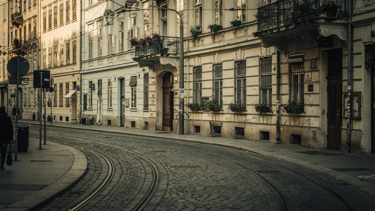 Vienna street facade with tram rails and morning light on the pavement